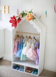 a white shoe rack with dresses hanging on it and text overlay that says how to organize your closet for dress up storage