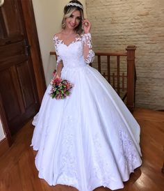 a woman in a wedding dress posing for the camera