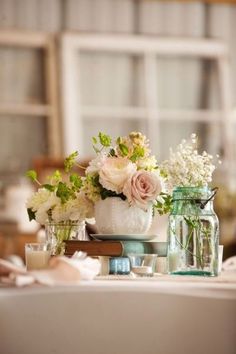 a table topped with vases filled with flowers