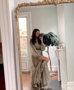 a woman sitting on a chair in front of a mirror