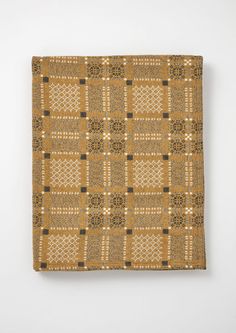 a brown and black patterned cloth on a white wall