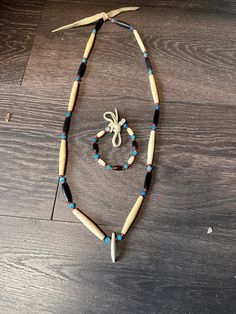 Necklace Measures; 30" around, commercial buckskin for decoration Resin Turquoise beads  Aged Buffalo bone and horn beads with glass spacer beads. Authentic Coyote tooth approx 1.5-2" each necklace is unique and you will get one similar to the one in the photo   Bracelet measures approx 7" (not including the buckskin ties)  NO INTERNATIONAL SHIPPING ARTIST NAME: Aodhàn Crawford  TRIBAL AFFILIATION: Cherokee  Item comes with a certificate of Native American / Celtic Made authenticity stating my enrollment information and signature. Native American Necklace For Men, Native American Beaded Necklace, Bones Bracelet, American Gifts, Native American Necklace, Native American Beading, Photo Bracelet, Native American Jewelry, Turquoise Beads