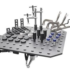 a metal table with tools on it and some screwdrives in the middle,