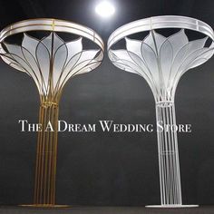 two white and gold lamps on display with the words the a dream wedding store