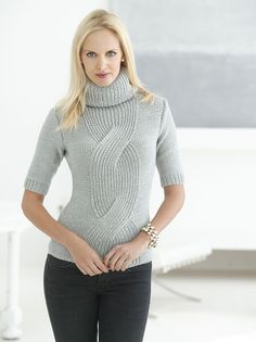 a woman in grey sweater and black pants