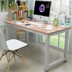 a desk with a computer on top of it in front of a book shelf filled with books