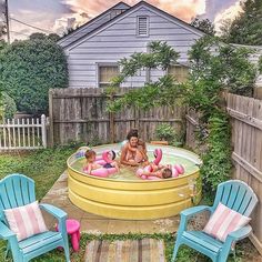 a woman and two children are in an above ground pool