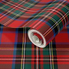 a red and green tartan plaid fabric with a white circle on the bottom right corner