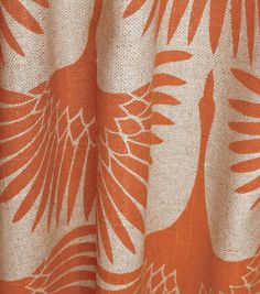 an orange and white curtain with birds on it