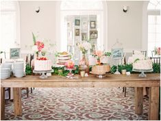 a table topped with lots of cakes and desserts