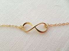 So sweet and adorable, you would want to wear it everyday! CHOOSE your length 15-18 inches. Fast shipping within 1-3 days Comes in a Gift Box . Ready for your special presentation -Matte gold plated infinity charm 21*8.5 mm -Gold plated chain -Lobster clasp . Please read the store policy before purchase www.etsy.com/shop/TiffanyAvenueBridal/policy?ref=shopinfo_policies_leftnav Thank you! ♥ Infinity Necklace With Delicate Chain For Wedding, Simple Gold Necklace For Bridesmaid Gift, Simple Gold Jewelry For Formal Occasions, Dainty Gold Infinity Necklace, Dainty Infinity Necklace For Wedding, Minimalist Gold Infinity Jewelry, Minimalist Infinity Gold Jewelry, Simple Infinity Jewelry For Anniversary, Handmade Gold Infinity Jewelry