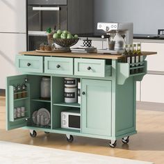 a green kitchen island with lots of drawers