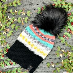 This double-layered knit beanie has a wide brim and a detachable faux fur pom pom. The inside of the hat is solid black, and you can reverse the hat entirely if you want to change up your look. This chunky knit hat was knitted on a hand-crank circular knitting machine. The faux leather tag and the faux fur pom on this hat are removable. This warm adult beanie is knitted with 100% acrylic yarn. This hat is made with a self-striping yarn; the item pictured is a representation of the item you will Black Yarn Beanie, Cold Weather Knit Beanie Hat, Black Knitted Acrylic Yarn Hat, Crochet Knit Hat For Cold Weather, Addi Machine, Sock Monkey Hat, Noir Uni, Circular Knitting Machine, Chunky Beanie