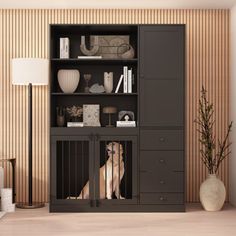 a dog is sitting in its cage next to the bookshelf and lamp on the floor