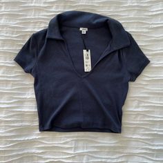 Garage Cropped Polo Tee, Navy, Size Medium. New And Unworn Polo Tank Top, Trendy Navy V-neck Top, Fitted Navy Collared Tops, Navy Fitted Collared Tops, Fitted Collared Navy Tops, Fitted Navy T-shirt For Spring, Navy Short Sleeve Top For Spring, Navy Trendy Tops For Spring, Trendy Navy Tops For Spring