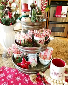 three tiered tray with candy canes and christmas decorations