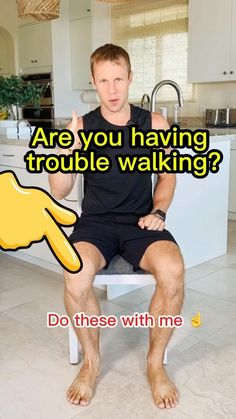 a man sitting on top of a kitchen counter with the caption are you having trouble walking? do these with me