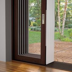 an open sliding glass door on a wooden floor