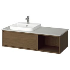 a bathroom sink with a wooden cabinet underneath it and a faucet on the side