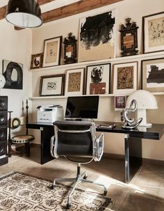 a home office with lots of art on the wall