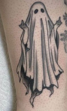 a black and white tattoo with a ghost on it