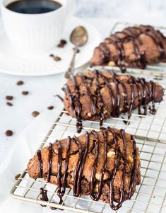 chocolate chip cookies with drizzled icing sitting on a wire cooling rack