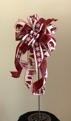 a red and white christmas bow sitting on top of a table