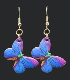 Beautiful Blue & Purple Butterfly Dangly Earrings!  Add these majestic winged friends to your jewelry!  These metal charms feature colorful insects with a Gold metal base, 1.25" tall dangling charm earrings.  Nickel free, Zinc alloy, hypoallergenic earrings.   Fun Fashion.   Great Gift Idea or just buy them for Yourself! Blue Purple Butterfly, Multicolor Butterfly Charm Earrings As Gift, Elegant Purple Butterfly Earrings, Colorful Insects, Artistic Purple Dangle Earrings, Blue Butterfly Charm Dangle Earrings, Unique Blue Butterfly-shaped Jewelry, Metal Charms, Dangly Earrings