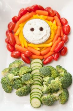 a plate topped with vegetables and a smiley face