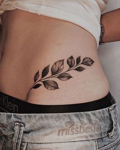 a woman's stomach with leaves on it