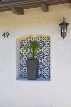 a potted plant sitting on top of a window sill next to a lamp