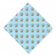 a blue dog paw print pocket square on a white background with multicolored paw prints