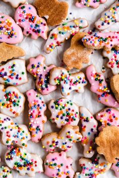 there are many different kinds of cookies on the table with colorful sprinkles