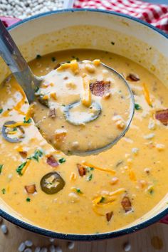 a spoon full of soup with cheese and bacon