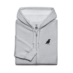 Designed with style and comfort in mind, this hoodie will quickly become your new favorite. It's made from soft fleece inside and outside, with a sturdy metal zipper, convenient front pockets, and a hood with color-matched drawstrings. This crow embroidered zip hoodie is available in 5 colours. For the size guide please see photos above. * 50% cotton, 50% polyester * Fabric weight: 8 oz/yd² (271 g/m²) * Yarn diameter: 20 singles * Soft fleece fabric inside and outside * Air-jet spun yarn for red Metal Zipper, Air Jet, Fleece Fabric, Pocket Pouch, Front Zipper, Zip Hoodie, Color Matching, Size Guide, Fabric Weights