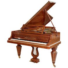 a grand piano with a wooden case and stand