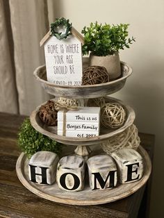 three tiered tray with home signs and plants