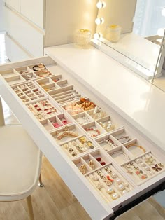 a white table topped with lots of jewelry