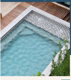 an outdoor swimming pool surrounded by wooden decking