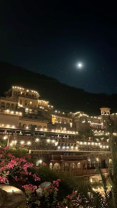 a night time view of a resort with lights on