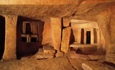 the interior of a cave with stone walls