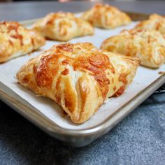 several pastries on a baking tray ready to be baked in the oven or used as an appetizer