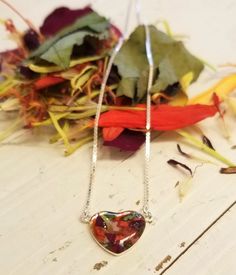 This lovely sterling silver heart pendant showcases a handcrafted flower-infused polymer clay stone. ◄Size Bead Dimension: 14mm ◄Color The color of the bead will depend on the color of the flowers you send and the color(s) of the polymer clay you select. We can create a single-color bead or design a blend of up to 3 colors. ◄Flowers Needed This pendant requires at least 8-10 petals to create. If you have smaller flowers such as hydrangea, mum, monkshood, etc., send a few more blooms. We keep you Hand Painted Heart-shaped Jewelry For Gifts, Sterling Silver Multicolor Jewelry With Heart Charm, Flower-shaped Sterling Silver Necklace For Valentine's Day, Flower Shaped Sterling Silver Necklaces For Valentine's Day, Valentine's Day Flower Shaped Sterling Silver Necklace, Hand Painted Heart Necklace For Gift, Hand Painted Heart Necklace For Gifts, Heart Beads Polymer Clay Jewelry Gift, Multicolor Heart Beads Sterling Silver Jewelry