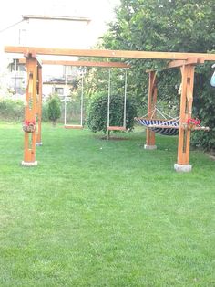 a hammock and swing set in a yard