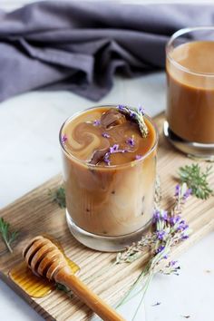 two glasses of iced coffee with lavender sprigs and honey on a cutting board