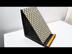 a black and yellow tie sitting on top of a white table