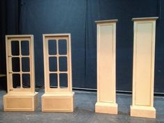 three tall wooden bookshelves sitting on top of a floor next to each other