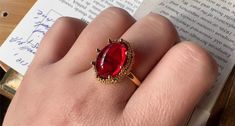 Embrace a regal allure with the Majesty Oval Ring. This striking piece showcases a deep red oval resin stone set in an intricate gold-tone band that adds a touch of vintage-inspired elegance to your jewelry collection. The bold color of the stone catches the light beautifully, creating a captivating glow with every movement. Designed for those who love to make a statement, this ring is perfect for special occasions or for adding a pop of color to your everyday outfits. Pair it with matching gold jewelry for a cohesive, glamorous look. Details Majesty Oval Ring in Red Gold pleated Adjustable opening Missy Jewelry Dragon Breath Collection Ornate Red Formal Rings, Ornate Red Ring With Intricate Design, Oval Red 14k Gold Jewelry, Matching Gold Jewelry, Ornate Oval Red Jewelry, Luxury Bohemian Red Rings, Dragon Breath, Resin Stone, Natural Stones Necklace