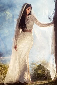 a woman in a white wedding dress and veil