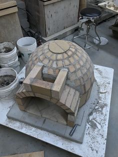 a brick oven sitting on top of a cement slab